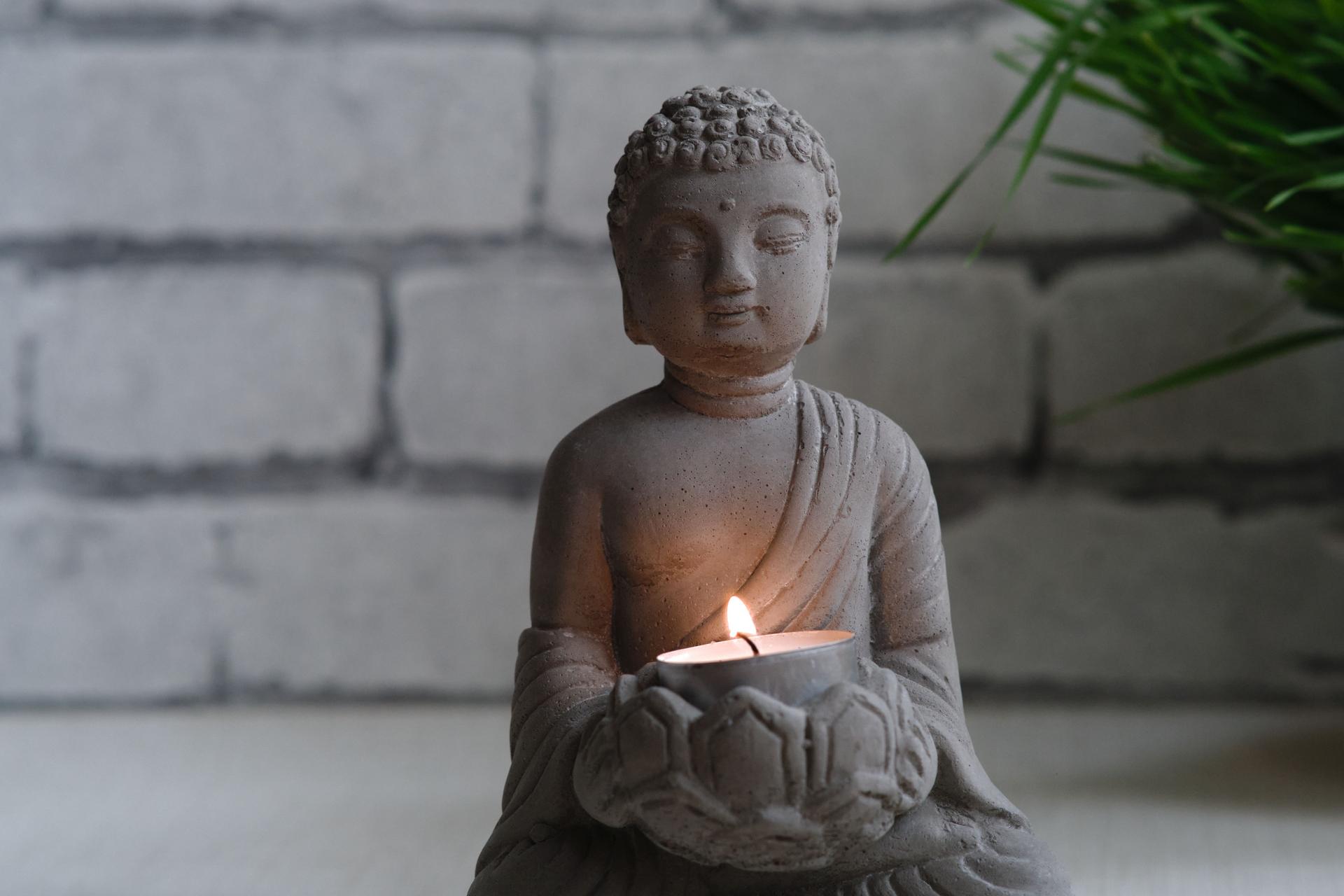 a small stone statue of Buddha