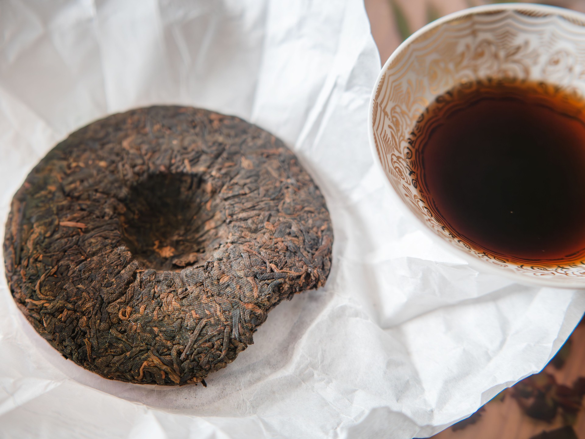 Traditional Pu-erh Tea Cake with Brewed Cup